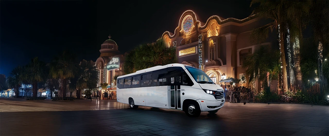 exterior of a casino and a white shuttle bus parked out front
