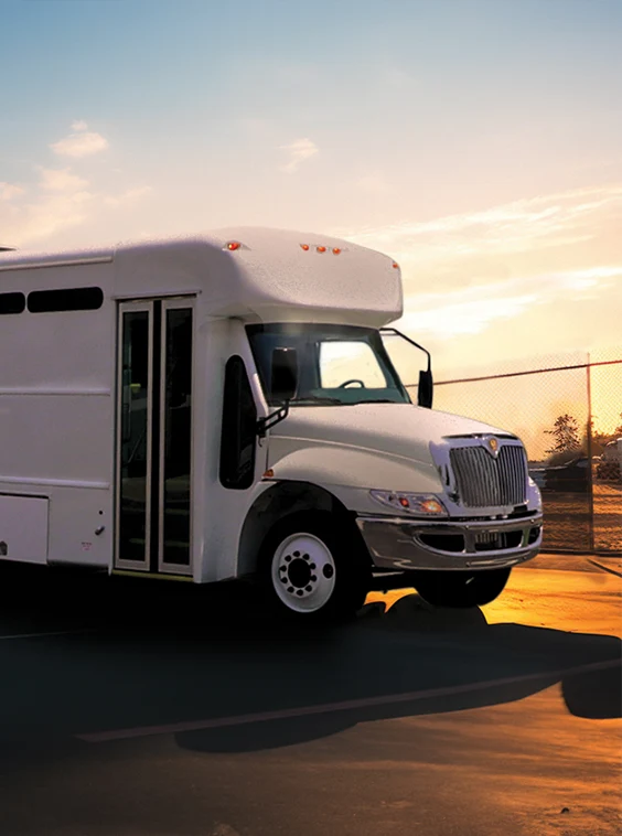 White shuttle bus parked next to a security fence at a prison near Orlando