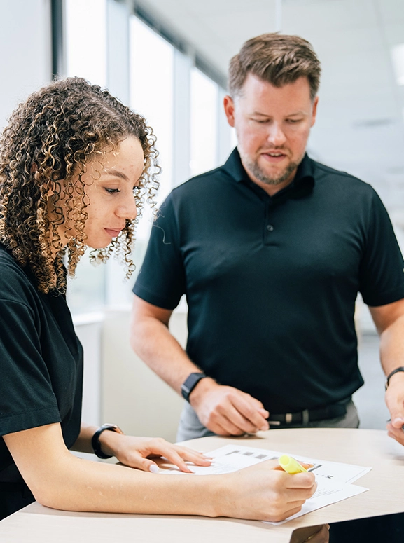 woman and man looking at forms for renting a vehicle in Orlando